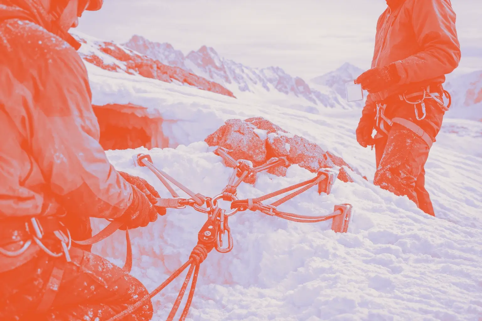 Two climbers prepare climbing gear on snow.